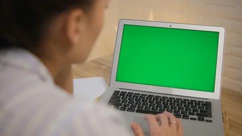 The concept of distance learning, work. Green computer screen. The girl sits at  Stock Footage 149285694