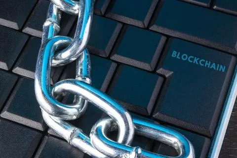Concept of distribution network technology blockchain. Chain on the keyboard. Stock Photos