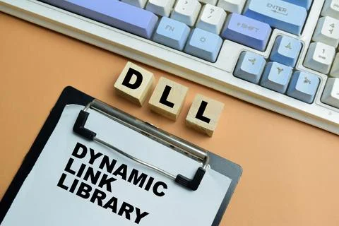 Concept of DLL - Dynamic Link Library write on clipboard isolated on table. Stock Photos