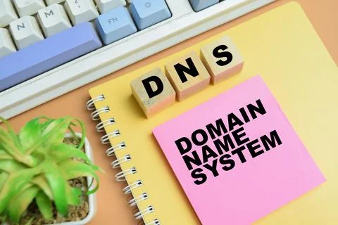 Concept of DNS - Domain Name System write on sticky notes isolated on table. Stock Photos