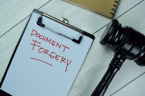 Concept of Document Forgery write on a paperwork with gavel Stock Photos