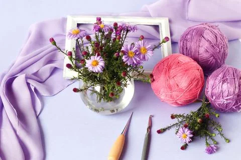 The concept of doing needlework. Tangles of purple and pink yarn, knitting to Stock Photos