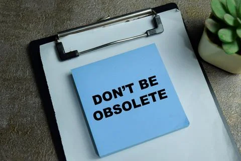 Concept of don't be obsolete write on sticky notes isolated on Wooden Table. 스톡 사진