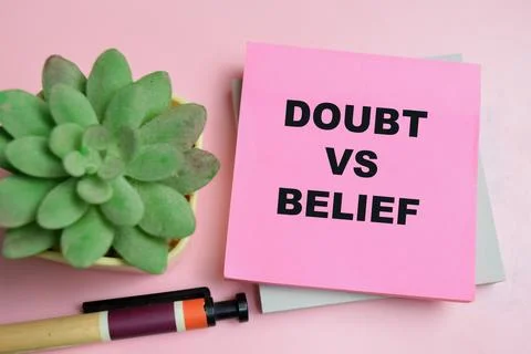 Concept of doubt vs belief write on sticky notes isolated on table. Stock Photos