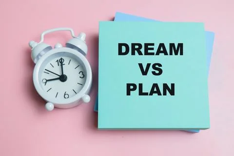 Concept of dream vs plan write on sticky notes isolated on table. Stock Photos