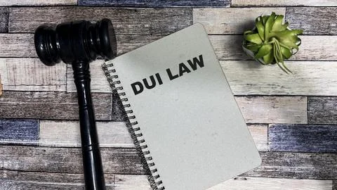 Concept of DUI LAW write on book isolated on Wooden Table. Stock Photos