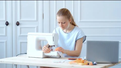 Concept during self-isolation and quarantine. Woman sews a mask Stock Photos