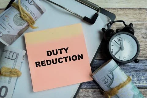 Concept of duty reduction write on sticky notes isolated on Wooden Table. Foto stock