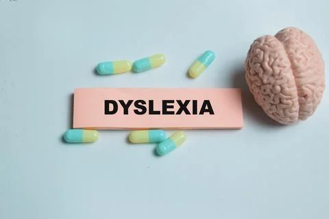 Concept of dyslexia write on sticky notes isolated on Wooden Table. Stock Photos