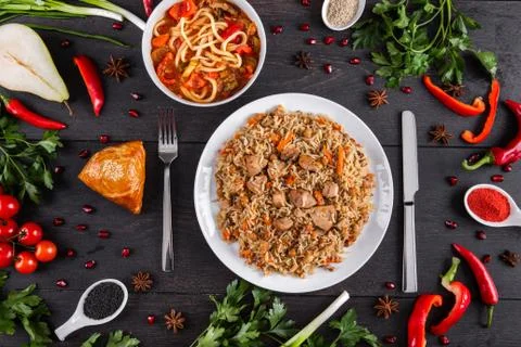 The concept of Eastern festive cuisine. Assorted Uzbek food set, pilaf, samsa Stock Photos