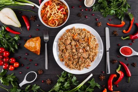 The concept of Eastern festive cuisine. Assorted Uzbek food set, pilaf, samsa Stock Photos