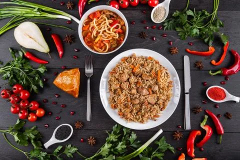 The concept of Eastern festive cuisine. Assorted Uzbek food set, pilaf, samsa Stock Photos