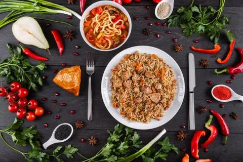 The concept of Eastern festive cuisine. Assorted Uzbek food set, pilaf, samsa Stock Photos