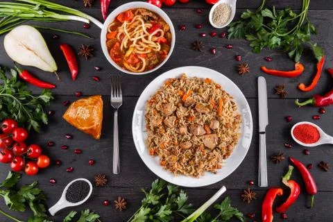 The concept of Eastern festive cuisine. Assorted Uzbek food set, pilaf, samsa Stock Photos
