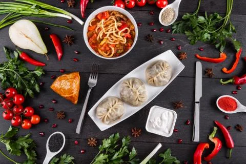 The concept of Eastern festive cuisine. Assorted Uzbek food set, pilaf, samsa Stock Photos