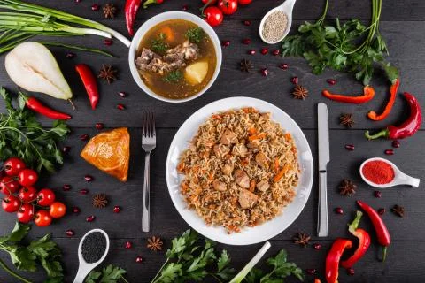 The concept of Eastern festive cuisine. Assorted Uzbek food set, pilaf, samsa Stock Photos