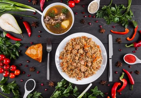 The concept of Eastern festive cuisine. Assorted Uzbek food set, pilaf, samsa Stock Photos