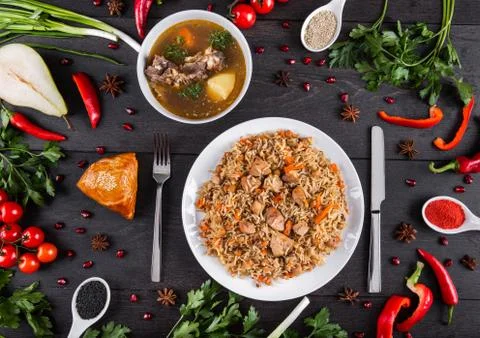 The concept of Eastern festive cuisine. Assorted Uzbek food set, pilaf, samsa Stock Photos