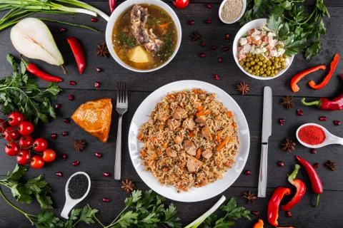 The concept of Eastern festive cuisine. Assorted Uzbek food set, pilaf, samsa Stock Photos