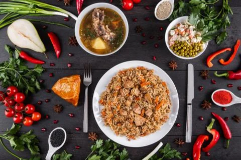 The concept of Eastern festive cuisine. Assorted Uzbek food set, pilaf, samsa Stock Photos