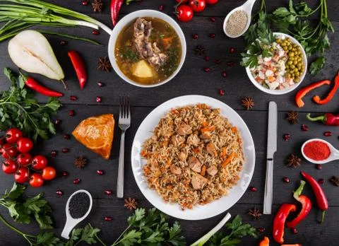 The concept of Eastern festive cuisine. Assorted Uzbek food set, pilaf, samsa Stock Photos
