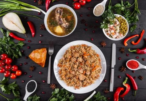 The concept of Eastern festive cuisine. Assorted Uzbek food set, pilaf, samsa Stock Photos