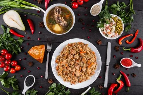 The concept of Eastern festive cuisine. Assorted Uzbek food set, pilaf, samsa Stock Photos