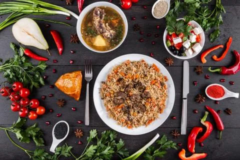 The concept of Eastern festive cuisine. Assorted Uzbek food set, pilaf, samsa Stock Photos