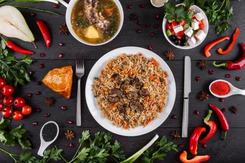 The concept of Eastern festive cuisine. Assorted Uzbek food set, pilaf, samsa Stock Photos