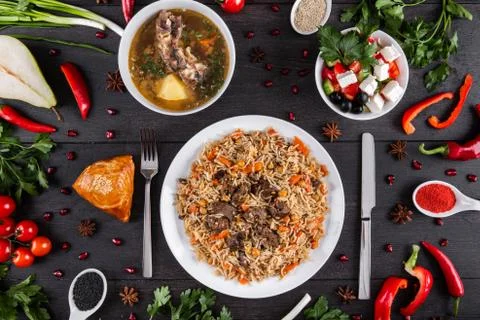 The concept of Eastern festive cuisine. Assorted Uzbek food set, pilaf, samsa Stock Photos