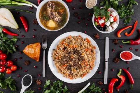 The concept of Eastern festive cuisine. Assorted Uzbek food set, pilaf, samsa Stock Photos