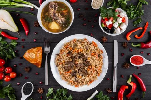 The concept of Eastern festive cuisine. Assorted Uzbek food set, pilaf, samsa Stock Photos