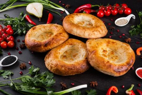 The concept of Eastern festive cuisine. Assorted Uzbek food set, pilaf, samsa Stock Photos