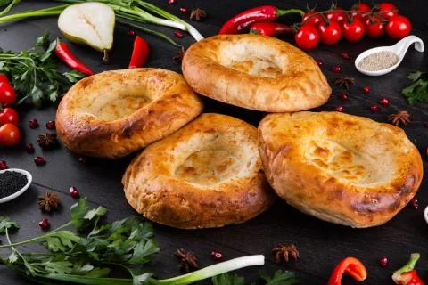 The concept of Eastern festive cuisine. Assorted Uzbek food set, pilaf, samsa Stock Photos