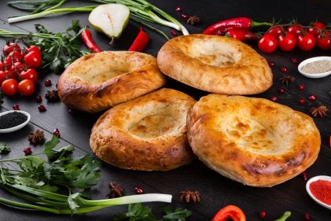 The concept of Eastern festive cuisine. Assorted Uzbek food set, pilaf, samsa Stock Photos