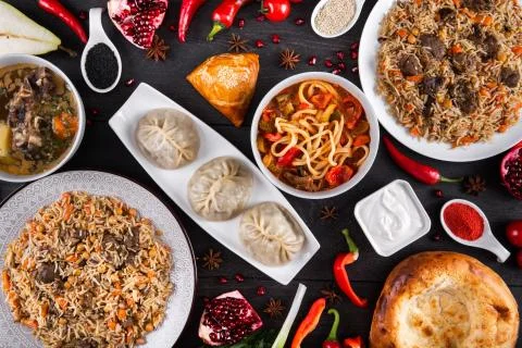 The concept of Eastern festive cuisine. Assorted Uzbek food set, pilaf, samsa Stock Photos