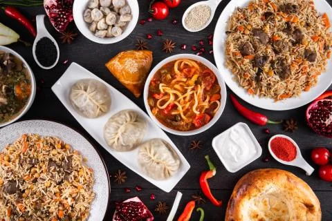 The concept of Eastern festive cuisine. Assorted Uzbek food set, pilaf, samsa Stock Photos
