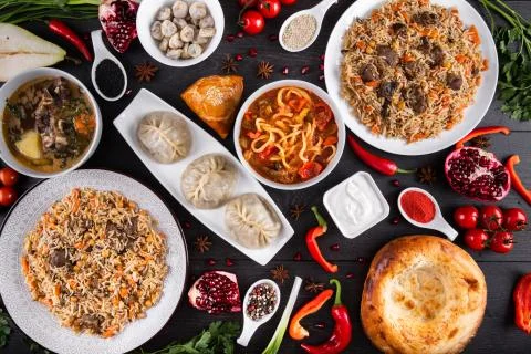 The concept of Eastern festive cuisine. Assorted Uzbek food set, pilaf, samsa Stock Photos