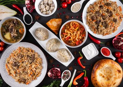 The concept of Eastern festive cuisine. Assorted Uzbek food set, pilaf, samsa Stock Photos