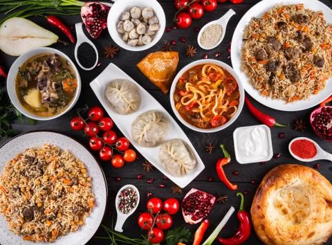 The concept of Eastern festive cuisine. Assorted Uzbek food set, pilaf, samsa Stock Photos