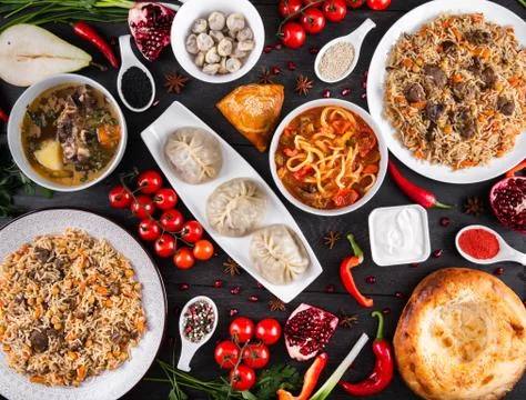 The concept of Eastern festive cuisine. Assorted Uzbek food set, pilaf, samsa Stock Photos