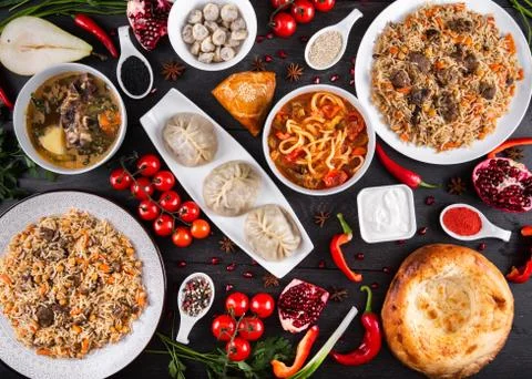 The concept of Eastern festive cuisine. Assorted Uzbek food set, pilaf, samsa Stock-Fotos
