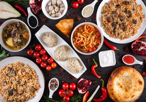The concept of Eastern festive cuisine. Assorted Uzbek food set, pilaf, samsa Stock Photos