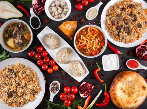 The concept of Eastern festive cuisine. Assorted Uzbek food set, pilaf, samsa Stock Photos