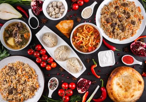 The concept of Eastern festive cuisine. Assorted Uzbek food set, pilaf, samsa Stock Photos