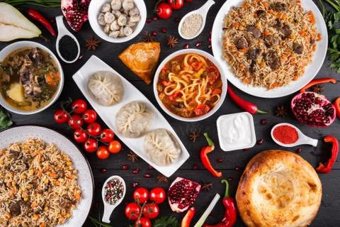 The concept of Eastern festive cuisine. Assorted Uzbek food set, pilaf, samsa Stock Photos
