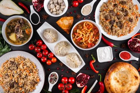The concept of Eastern festive cuisine. Assorted Uzbek food set, pilaf, samsa Stock Photos