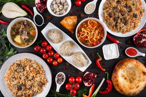 The concept of Eastern festive cuisine. Assorted Uzbek food set, pilaf, samsa Stock Photos