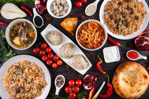 The concept of Eastern festive cuisine. Assorted Uzbek food set, pilaf, samsa Stock Photos