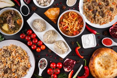 The concept of Eastern festive cuisine. Assorted Uzbek food set, pilaf, samsa Stock Photos